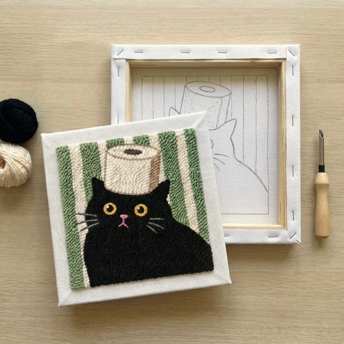 Finished Le Chat Pensif punch needle artwork styled in a home interior.
