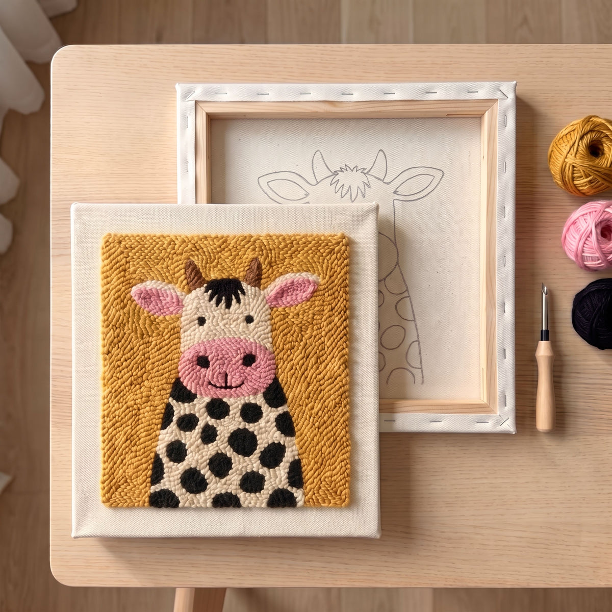 Finished Douce Vache punch needle artwork styled in a home interior.