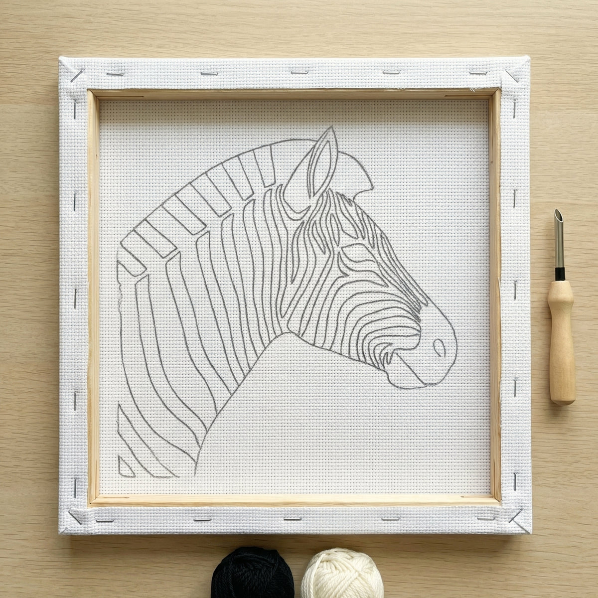 Finished Zèbre Minimaliste punch needle artwork styled in a home interior.