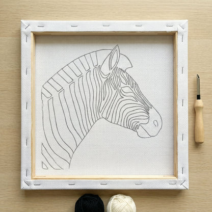 Finished Zèbre Minimaliste punch needle artwork styled in a home interior.