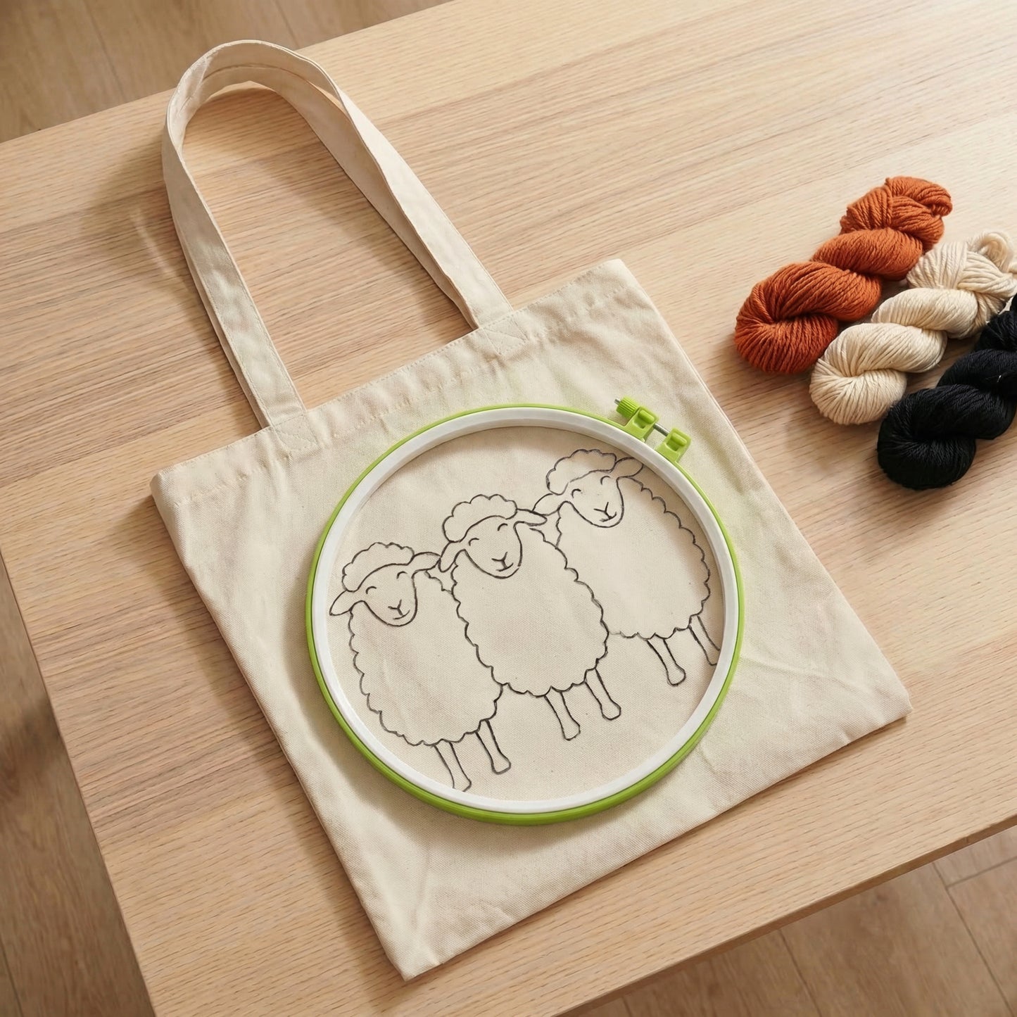 Tonia Art DIY kit for red sheep tote bag - Patterned bag, red yarn, embroidery hoop, and tools.
