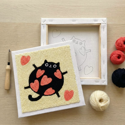 Finished Amour de Chat punch needle artwork styled in a home interior.