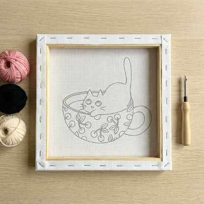 Finished Chaton aux Cerises punch needle artwork styled in a home interior.
